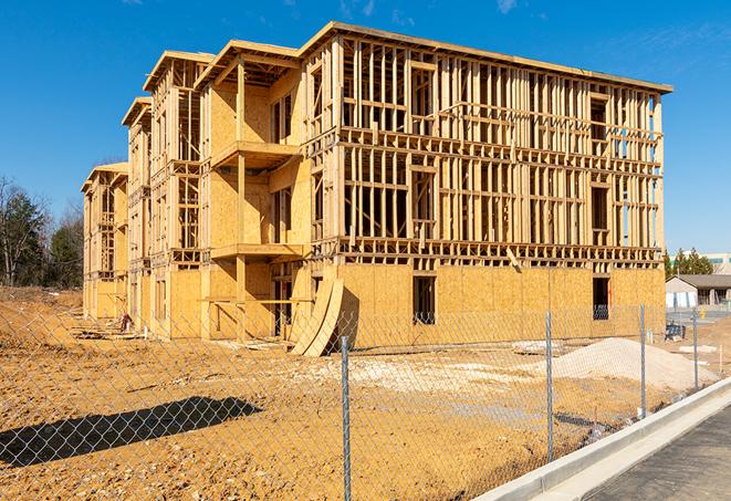 a temporary chain link fence in front of a building under construction, ensuring public safety in Gobles, MI